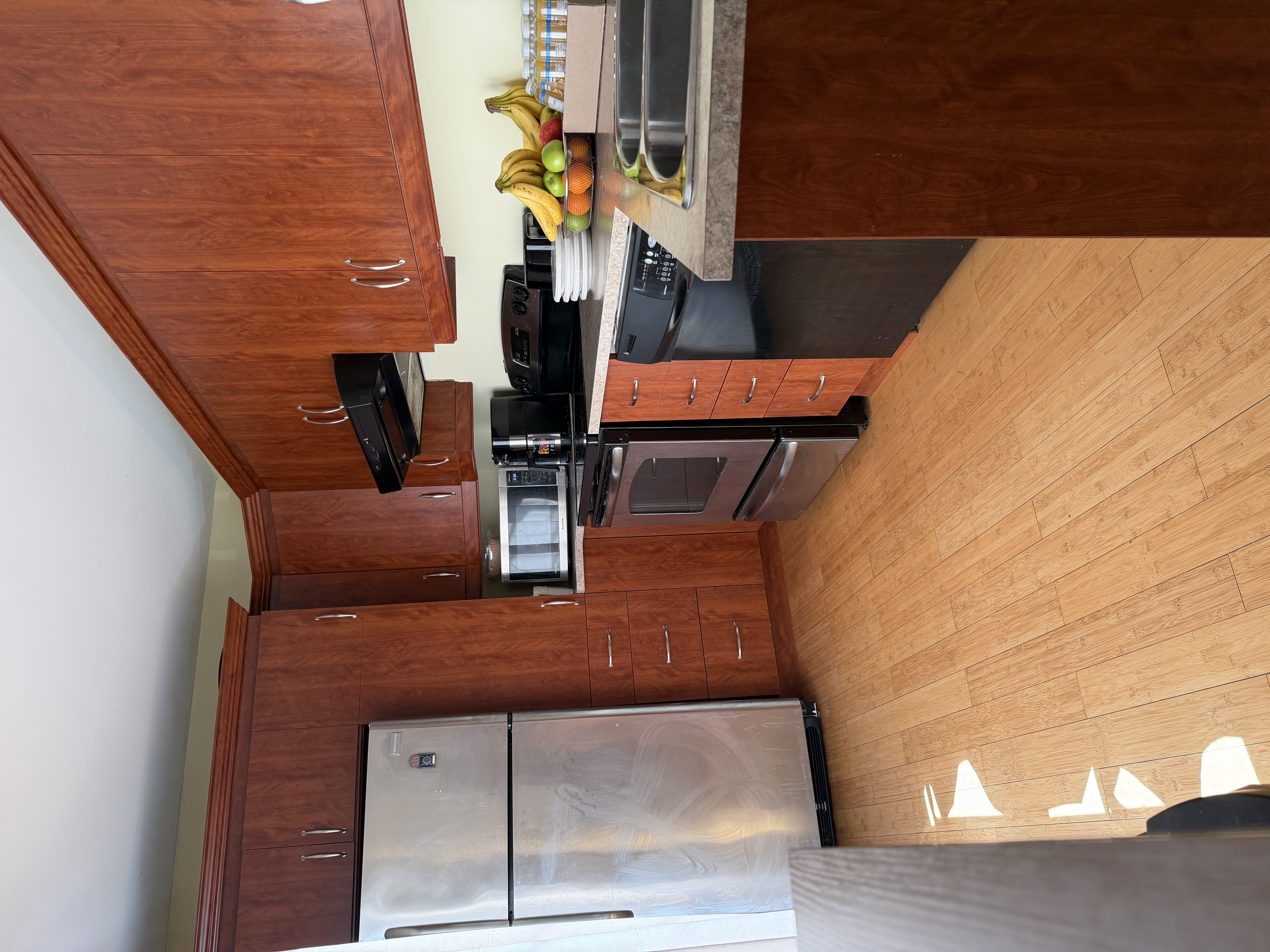 Shared accommodation kitchen with refrigerator, stove, microwave, dishwasher, and countertop space available for SonoRAY course participants