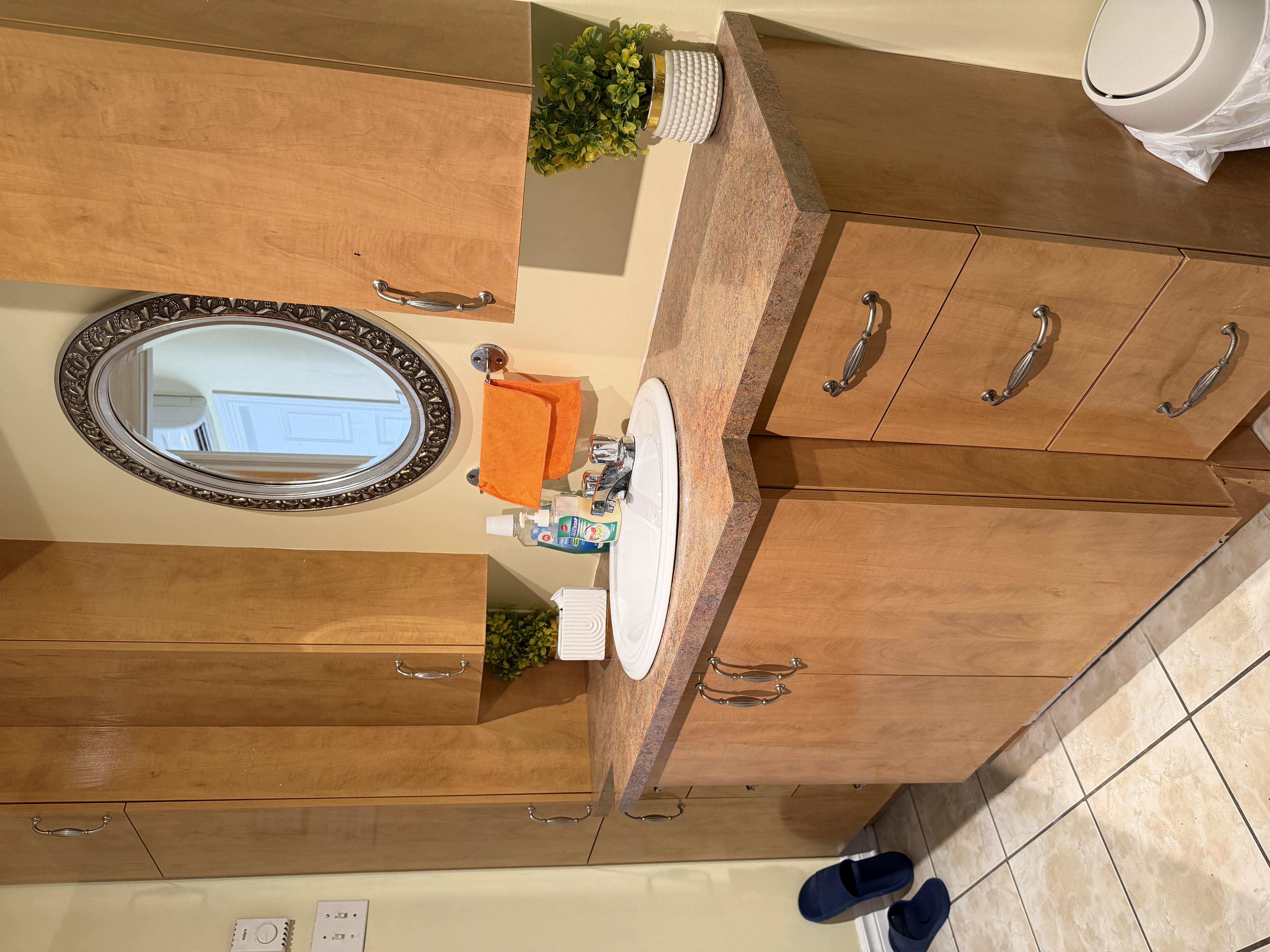 Clean bathroom vanity area with sink, mirror, and storage space available within SonoRAY course accommodation