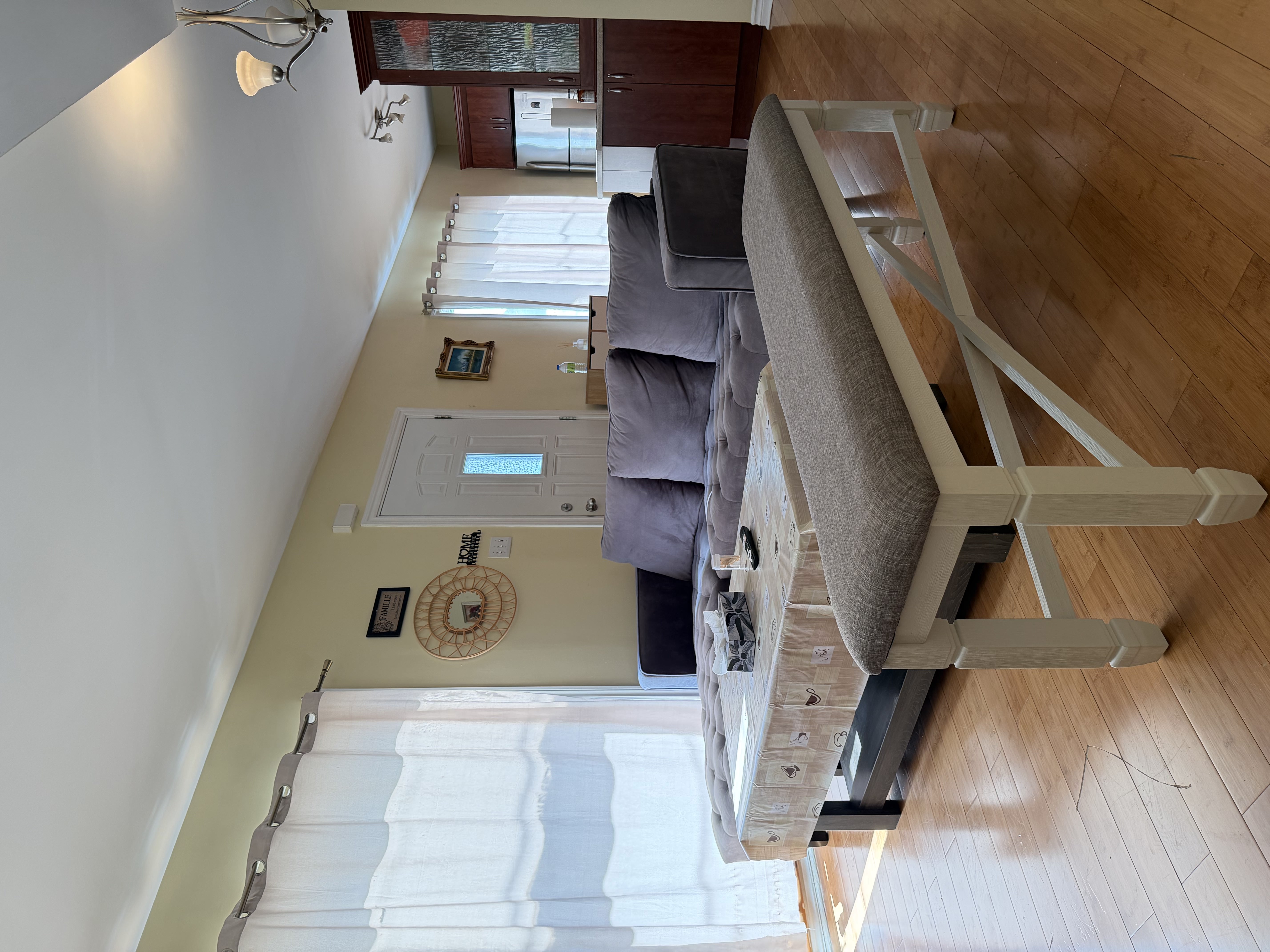 Bright shared accommodation living room with sofa, coffee table, dining area, and kitchen space provided for SonoRAY course participants