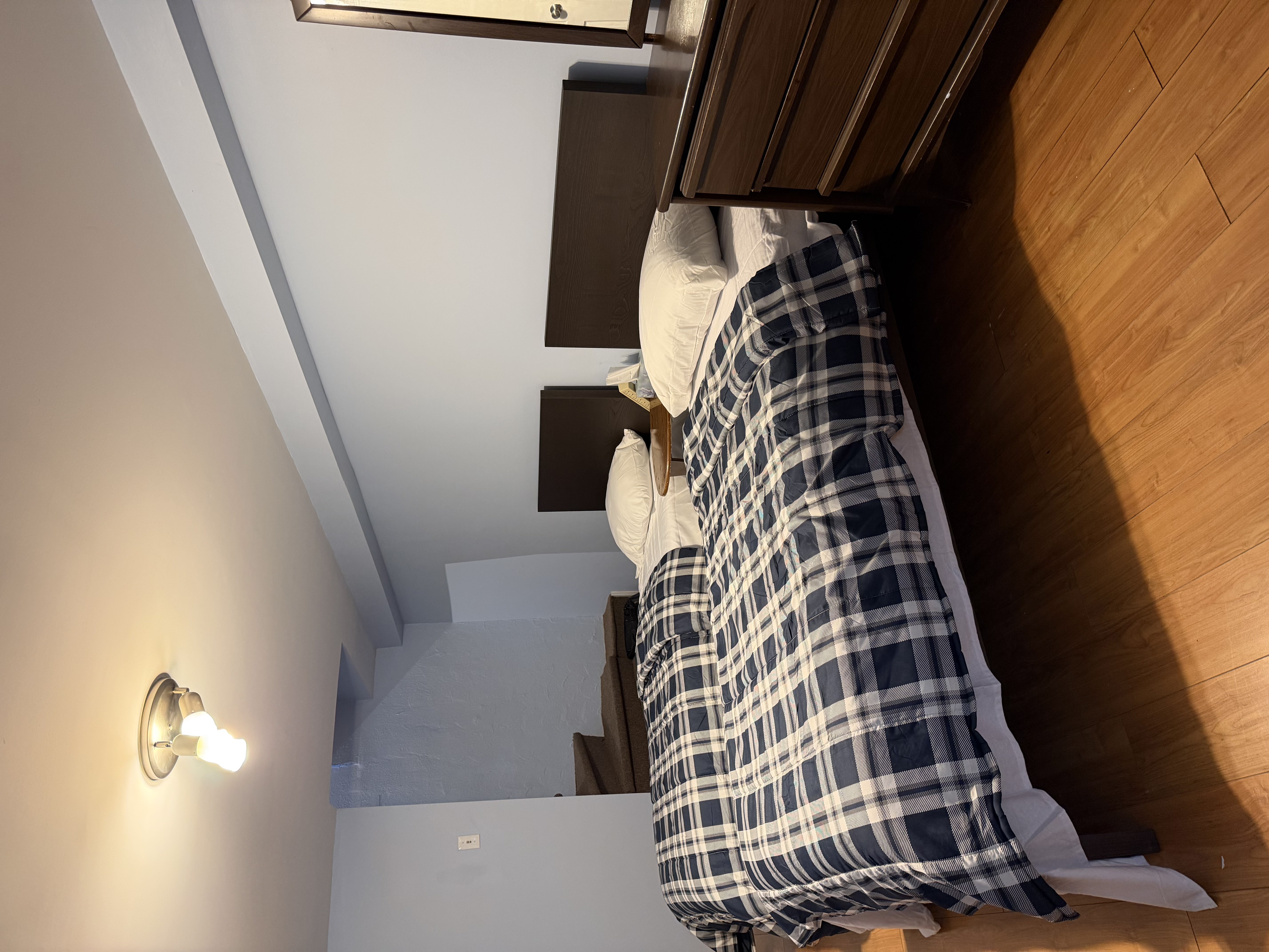 Shared bedroom with multiple beds, clean bedding, and storage furniture available for SonoRAY course participants